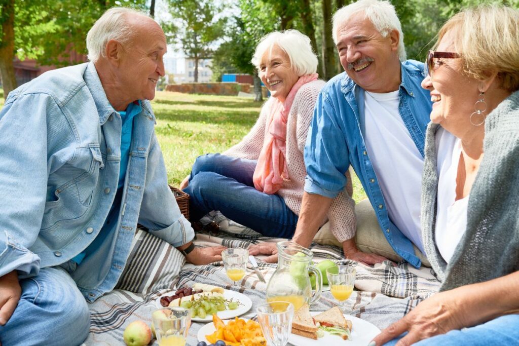 Old people having a picnic outdoors